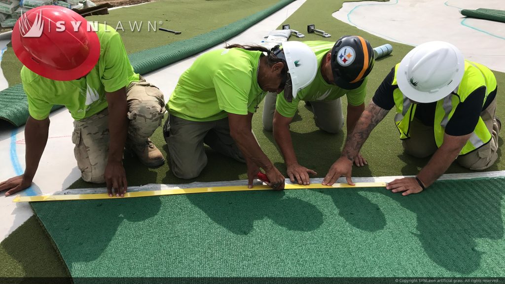 image of crew installing synthetic golf turf indianapolis childrens museum golf course