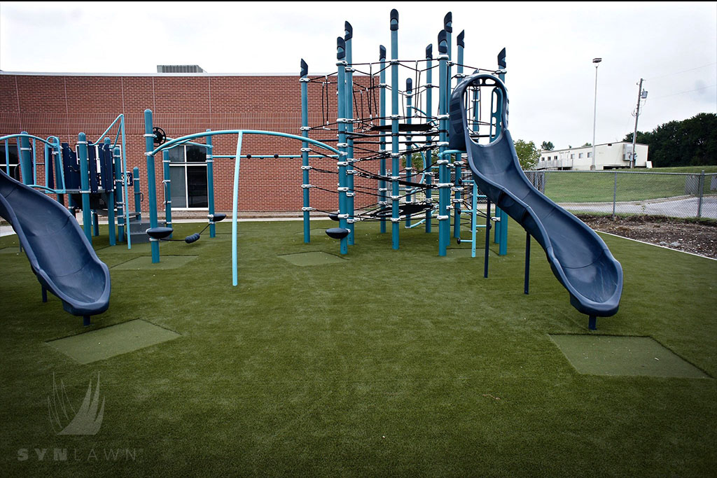 image of navy slides at lee’s summit mo playground with safe artificial grass