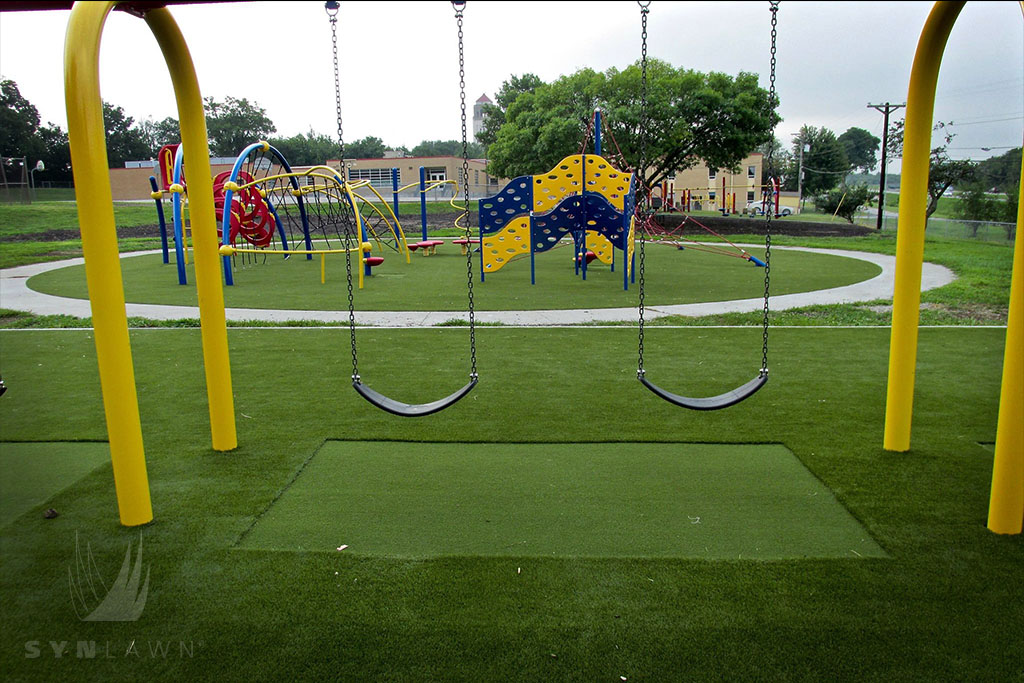 image of underwood elementary swing set with fake turf