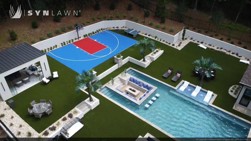 image of SYNLawn artificial grass at Bella Fine Custom Homes with pool surround and SYNCourt basketball court Georgia