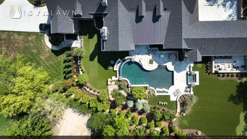 image of SYNLawn artificial grass backyard putting green pool surround and bocce court at Tennessee residential home