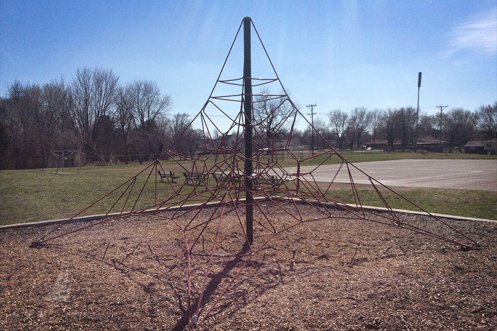 before image of greenwood elementary school playground climbing equipment over wood mulch