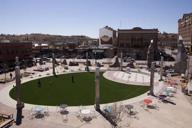 Rapid City residents enjoy the new artificial grass at Main Street Square