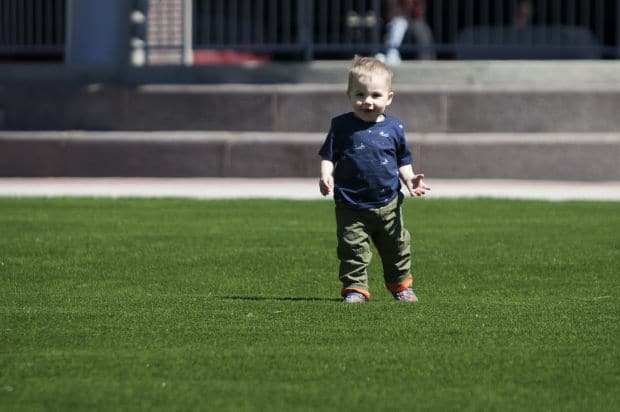 Bridger Krynski, 1, runs on the new artificial grass this week at Main Street Square