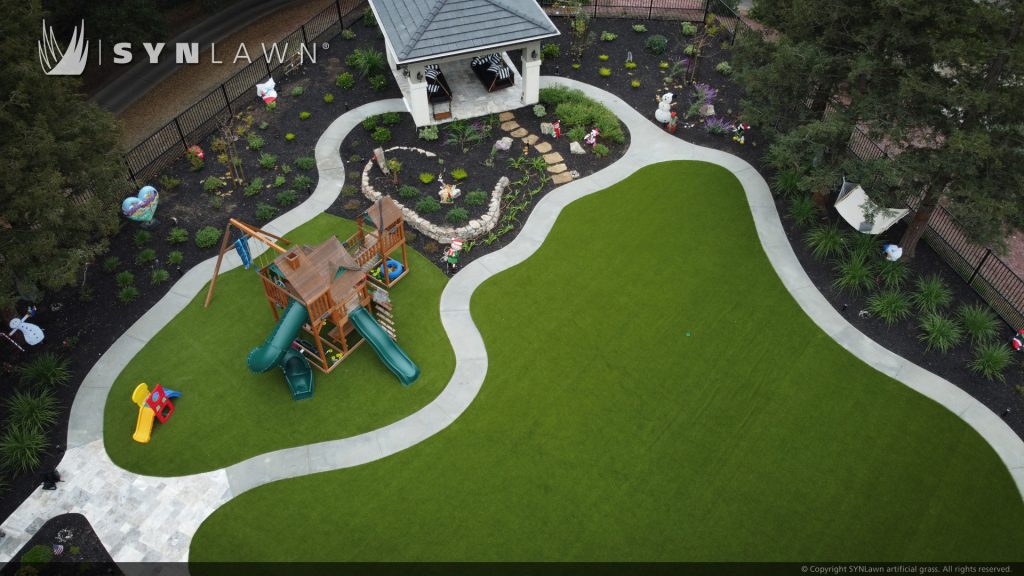image of artificial grass backyard with golf putting green kid play area and pool surround in San Francisco Bay Area California