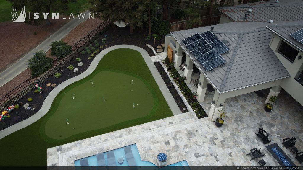 image of artificial grass backyard with golf putting green kid play area and pool surround in San Francisco Bay Area California