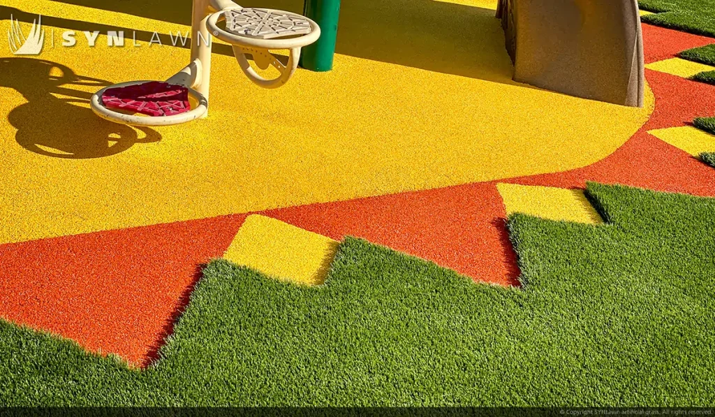 image of SYNLawn artificial playground grass with poured in place rubber surfacing at the young at heart learning center in Rock Springs Wyoming