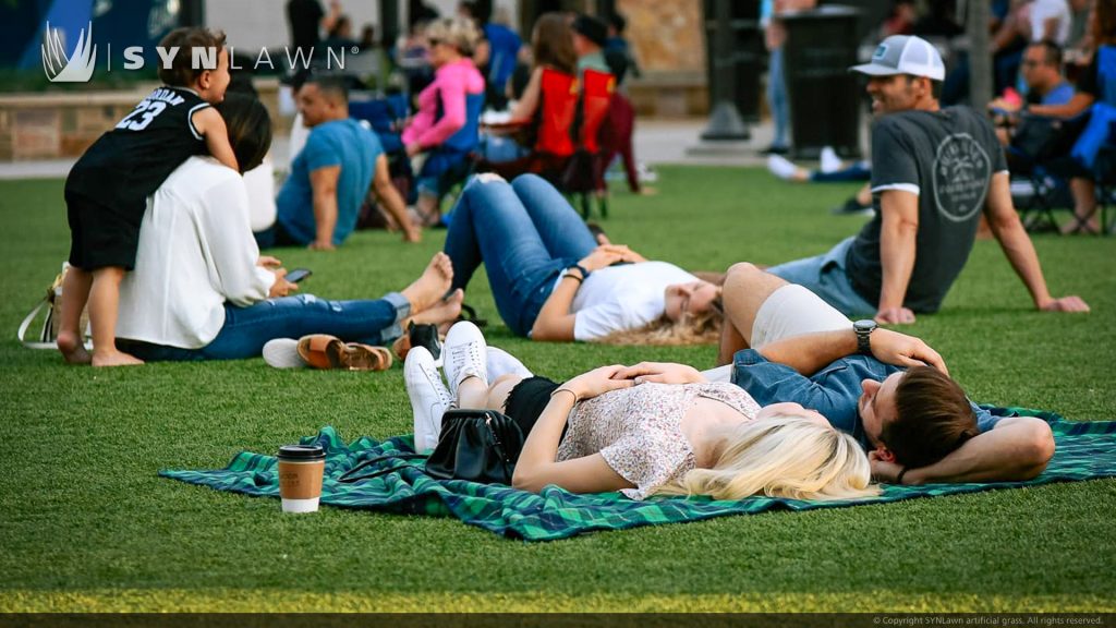 image of SYNLawn artificial grass at The Colony Grandscape Dallas Texas Retail Shopping Center Event Lawn for outdoor entertainment space