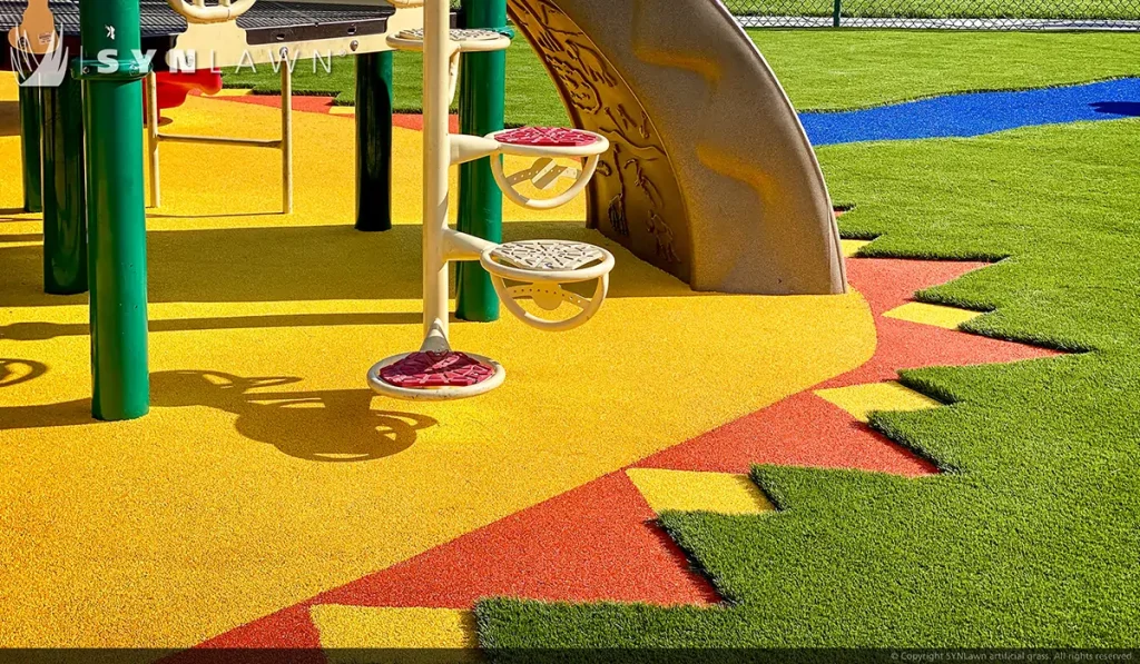 image of SYNLawn artificial playground grass with poured in place rubber surfacing at the young at heart learning center in Rock Springs Wyoming