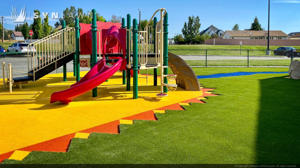 image of SYNLawn artificial playground grass with poured in place rubber surfacing at the young at heart learning center in Rock Springs Wyoming