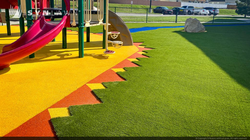 image of SYNLawn artificial playground grass with poured in place rubber surfacing at the young at heart learning center in Rock Springs Wyoming
