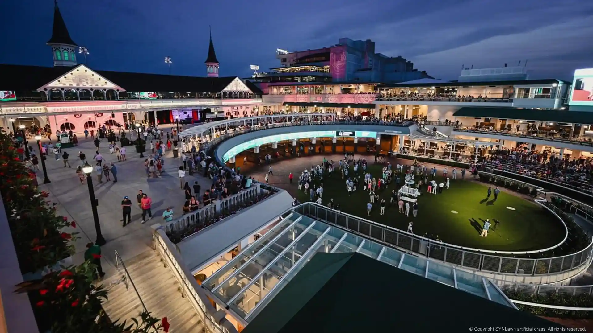 Kentucky Derby attendees enjoying a nice mint julip on the paddock covered in SYNLawn artificial grass image of the churchill downs paddock with synlawn artificial grass at the kentucky derby
