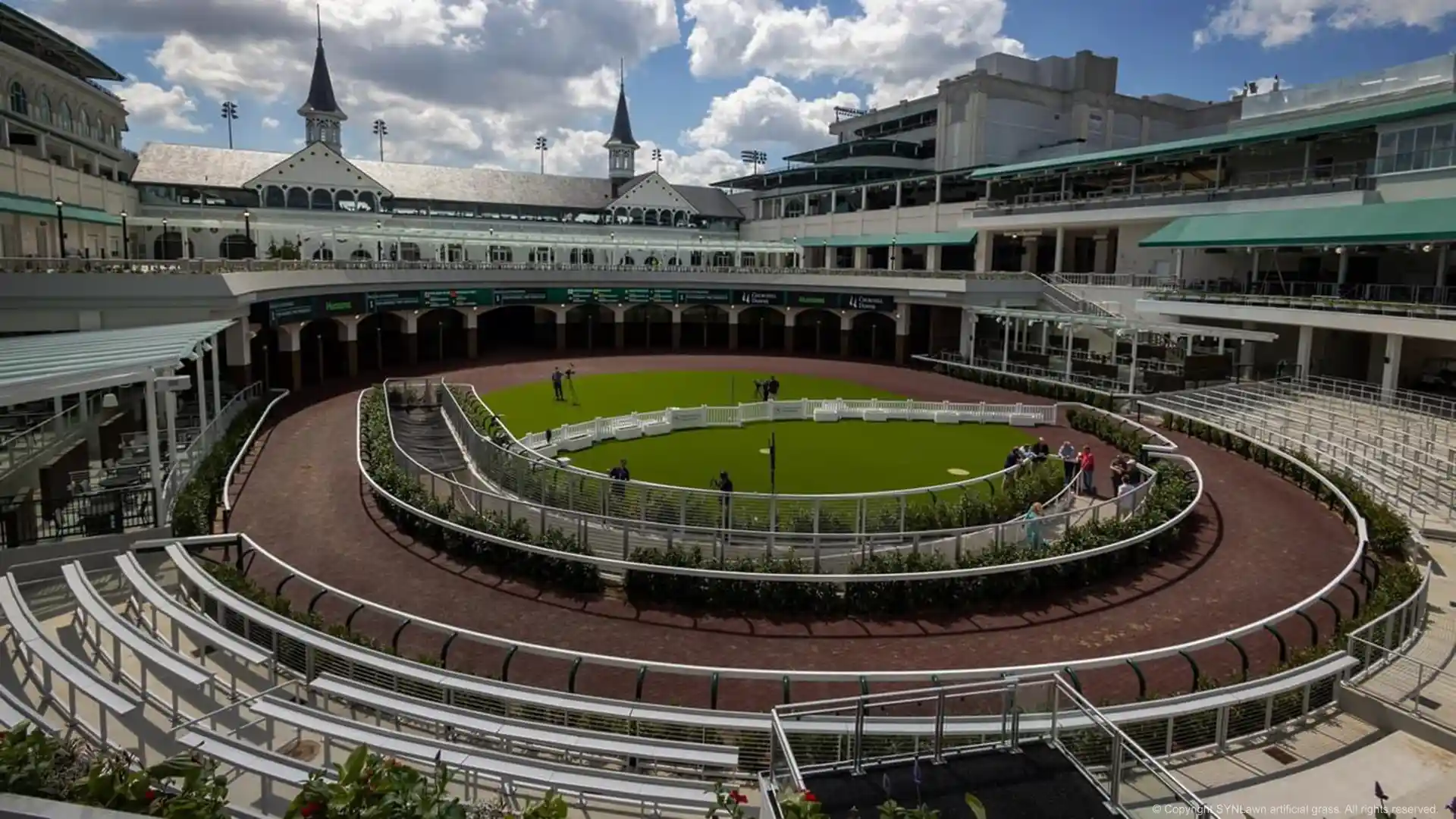 Kentucky Derby attendees enjoying a nice mint julip on the paddock covered in SYNLawn artificial grass image of the churchill downs paddock with synlawn artificial grass at the kentucky derby