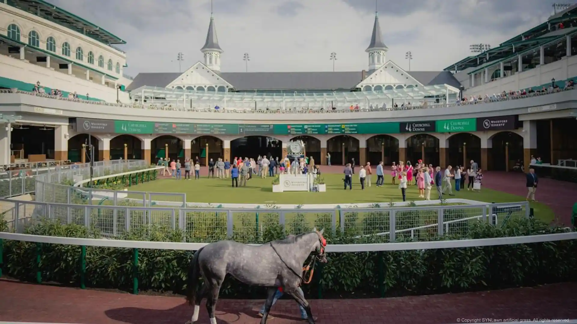 Kentucky Derby attendees enjoying a nice mint julip on the paddock covered in SYNLawn artificial grass image of the churchill downs paddock with synlawn artificial grass at the kentucky derby