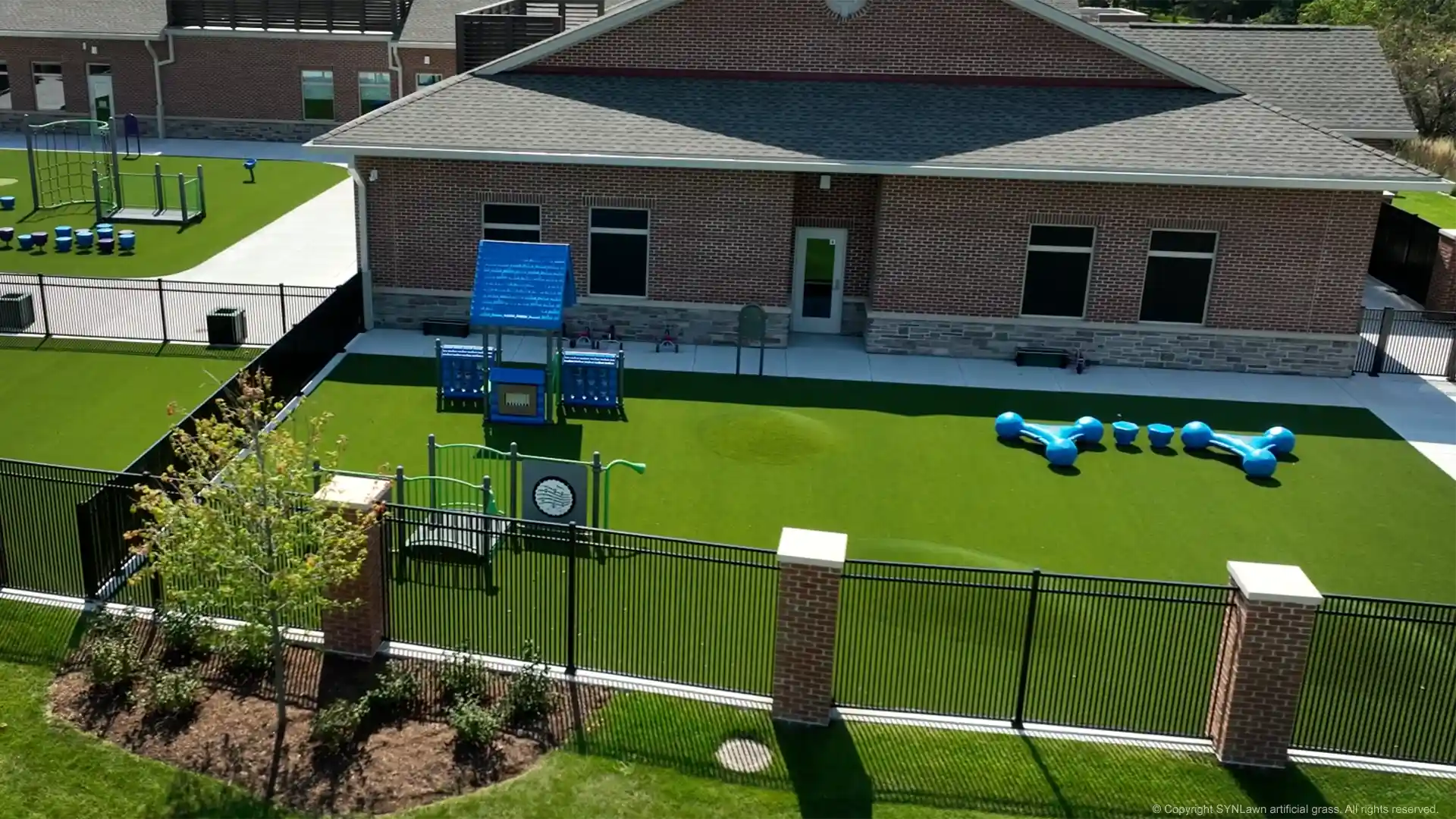 Child-safe playground turf installed by SYNLawn Chicago at the Everbrook Academy image of synlawn artificial playground grass at everbrook academy in chicago illinois